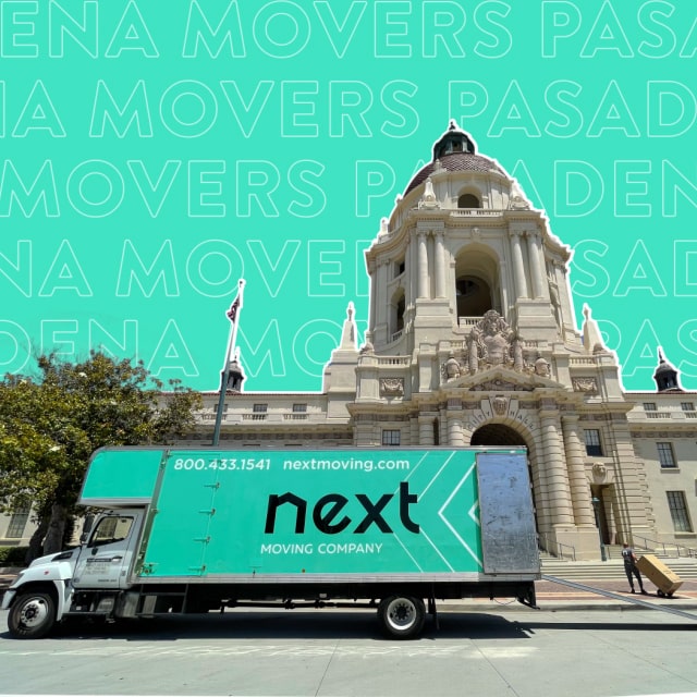 Next Moving local Pasadena movers providing moving services in Pasadena, California City Hall. 28-foot box truck with attic with Next Moving corporative decals on it, and opened back door is parked at the front of the Pasadena City Hall. The decal on the side of the truck shows the 800.433.1541 phone number nextmoving.com website and a large Next Moving logo on branded mint color background. Professional Pasadena local mover is pooling a wardrobe box towards the Pasadena City Hall to the right from the truck.