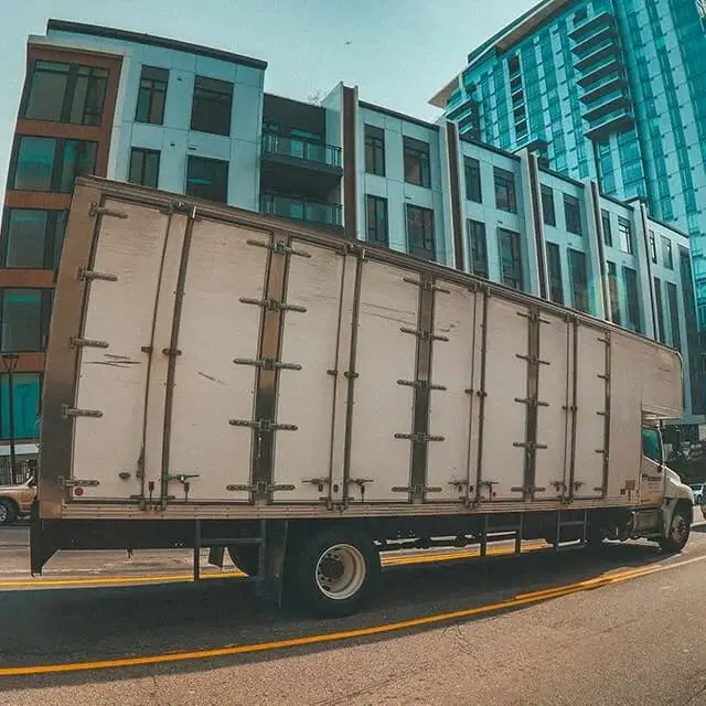 Next Moving newest, eco friendly, capacious moving trucks near me with four double side doors, ramp, swing back doors and atticparked parked in San Diego downtown.