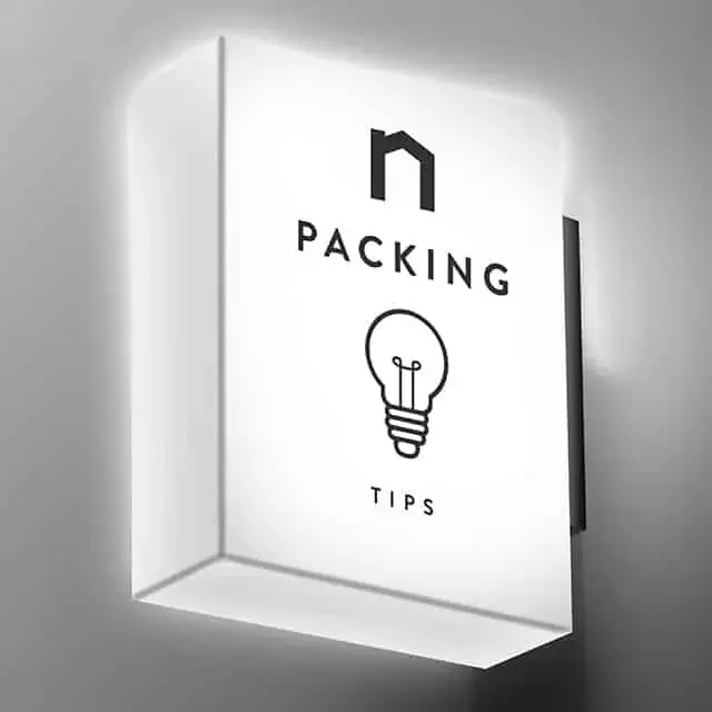 Square lamp with Next Moving logo and packing hacks, packing tips, packing tips for moving, moving packing tips, packing hacks for moving, moving packing hacks, packing hacks moving text on it shines white light.