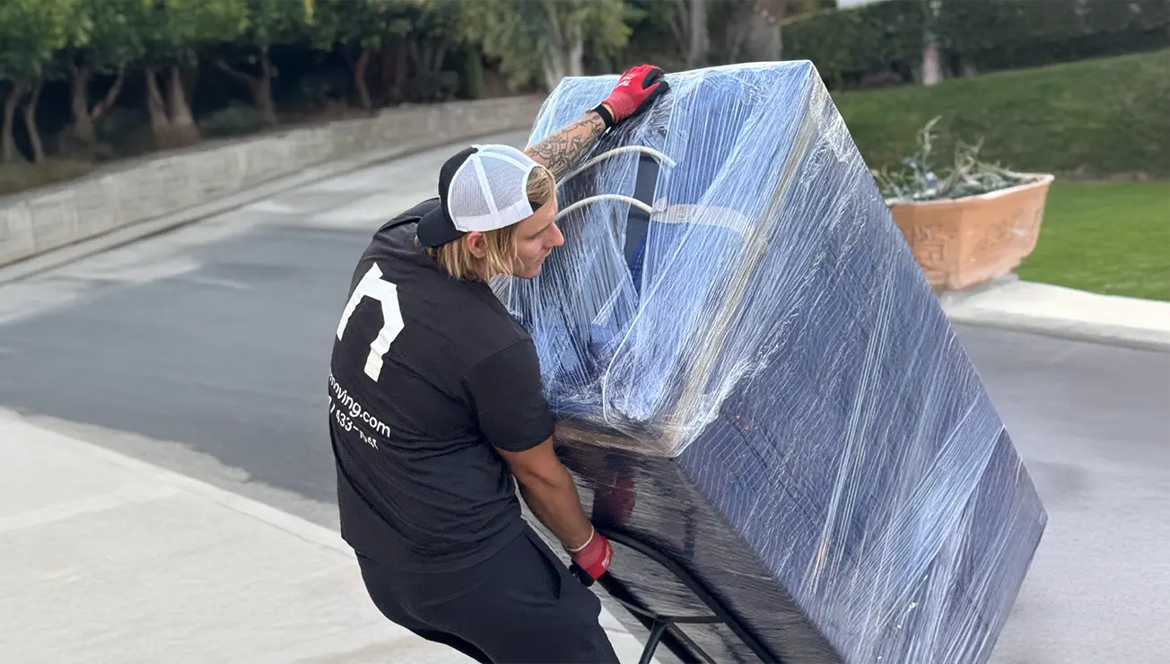 Two movers carrying boxes - movers cost per hour for local move